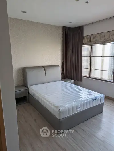 Modern bedroom with large window and stylish decor in urban apartment