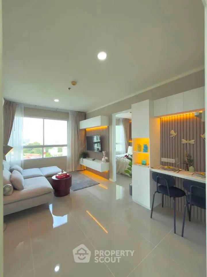 Modern open-plan living room with stylish decor and large window view