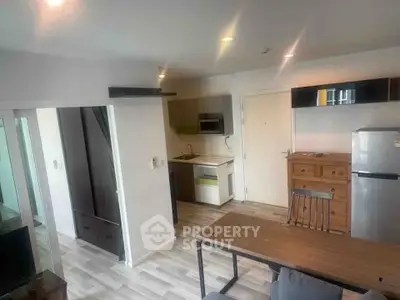 Modern open-plan kitchen and dining area with sleek appliances and stylish decor.