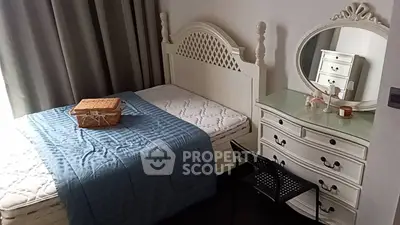 Charming bedroom with elegant white furniture and cozy decor, perfect for a peaceful retreat.