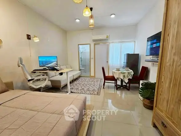 Modern studio apartment with open layout, featuring a cozy bed, stylish seating area, and contemporary decor.