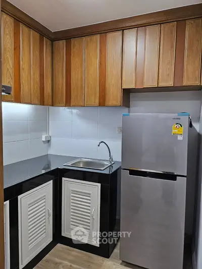 Modern kitchen with sleek fridge and stylish cabinetry