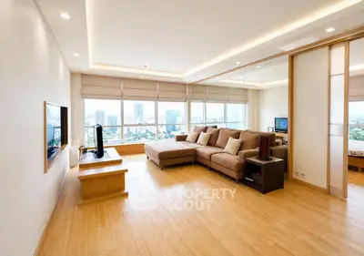 Spacious modern living room with large windows and city view
