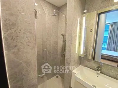 Modern bathroom with sleek shower and elegant sink in luxury apartment