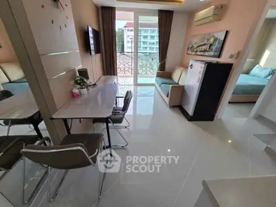 Modern apartment interior with open living and dining area, stylish decor, and balcony view.