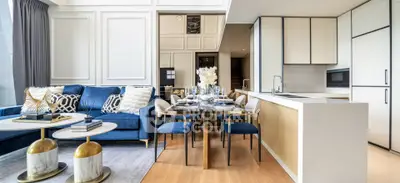 Luxurious modern living room with open kitchen, elegant decor, and stylish furniture
