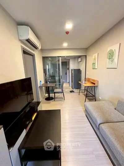 Modern living room with sleek furniture and air conditioning, perfect for urban living.