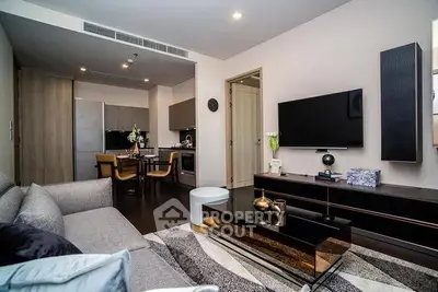 Modern living room with stylish decor and open kitchen layout in a contemporary apartment.
