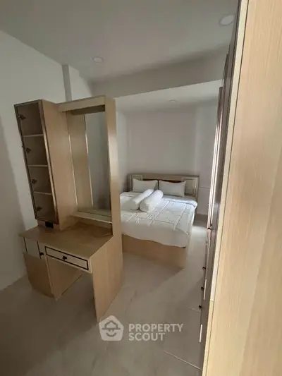 Cozy bedroom with modern furniture and neutral tones, perfect for relaxation.