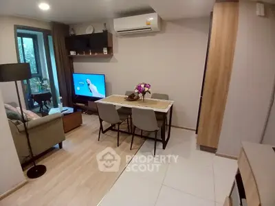 Modern living room with dining area and balcony view