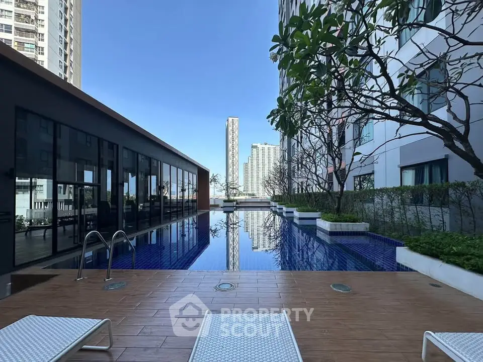 Luxurious condominium pool area with modern design and city views, perfect for relaxation and leisure.