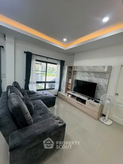 Modern living room with sleek design, large sofa, and entertainment center, perfect for relaxation and entertainment.