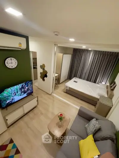 Modern studio apartment with open layout, featuring cozy living area and stylish bedroom.