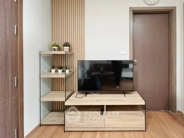 Modern living room with stylish TV stand and wooden flooring