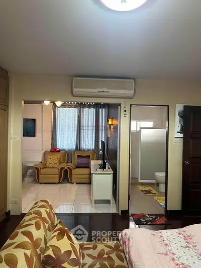 Cozy living room with adjacent bathroom in a stylish apartment