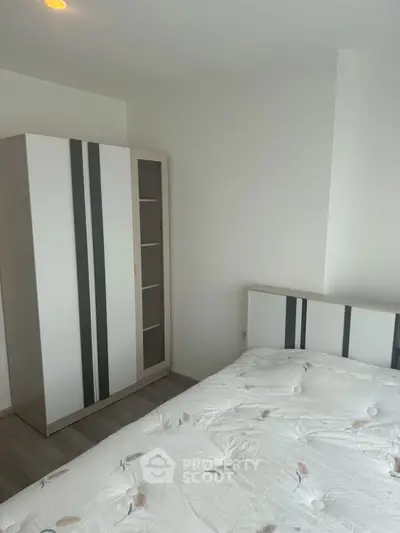 Modern minimalist bedroom with sleek wardrobe and cozy bed