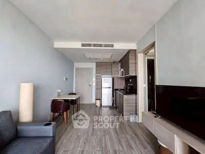 Modern open-plan living room with sleek kitchen and stylish decor