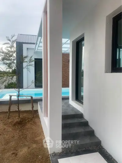 Modern exterior with sleek design and poolside view