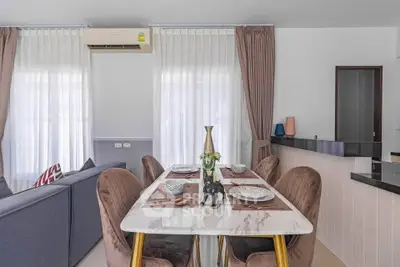 Stylish dining area with elegant table setting and modern decor in a cozy living space.