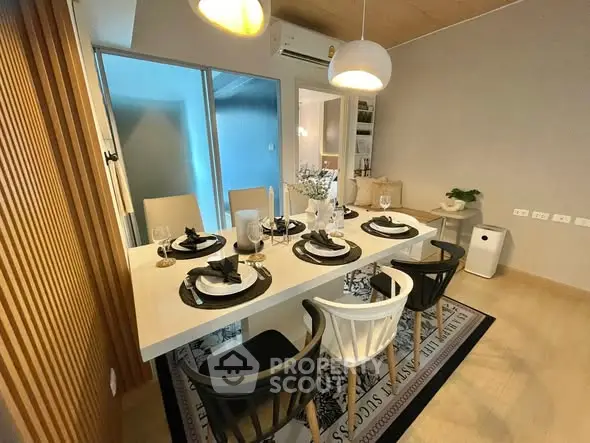 Modern dining room with elegant table setting and stylish lighting in a contemporary apartment.