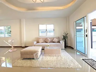 Spacious living room with modern decor and large windows for natural light.