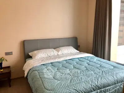 Cozy bedroom with modern decor and large window for natural light