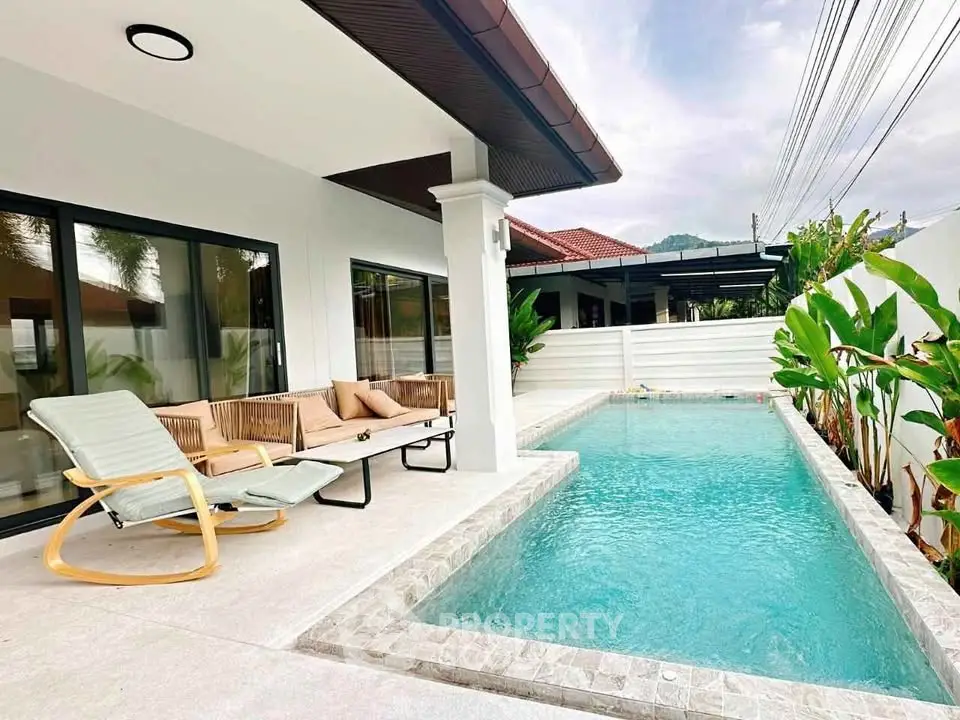 Modern villa with private pool and stylish outdoor seating area, perfect for relaxation.