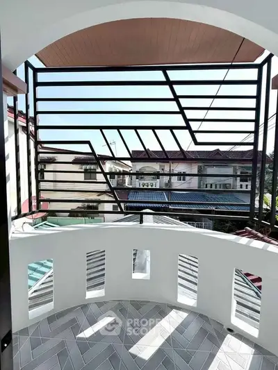 Charming balcony with modern railing and neighborhood view, perfect for relaxation and enjoying the outdoors.