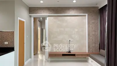 Modern living room with elegant wall design and built-in seating area.