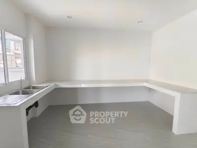 Spacious minimalist kitchen with ample counter space and natural light