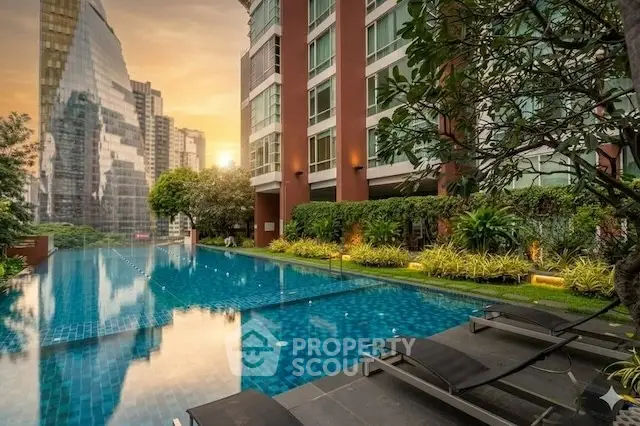 Luxurious urban apartment with stunning pool and city skyline view at sunset.