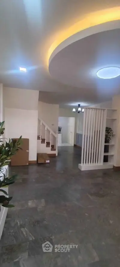 Spacious modern living room with elegant ceiling design and open layout