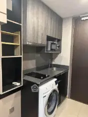 Modern compact kitchen with washing machine and sleek cabinetry