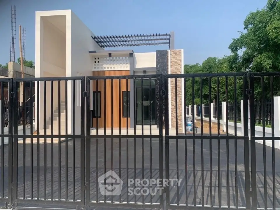 Modern minimalist house with sleek design and gated entrance