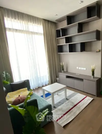 Cozy living room with modern shelving and large window for natural light