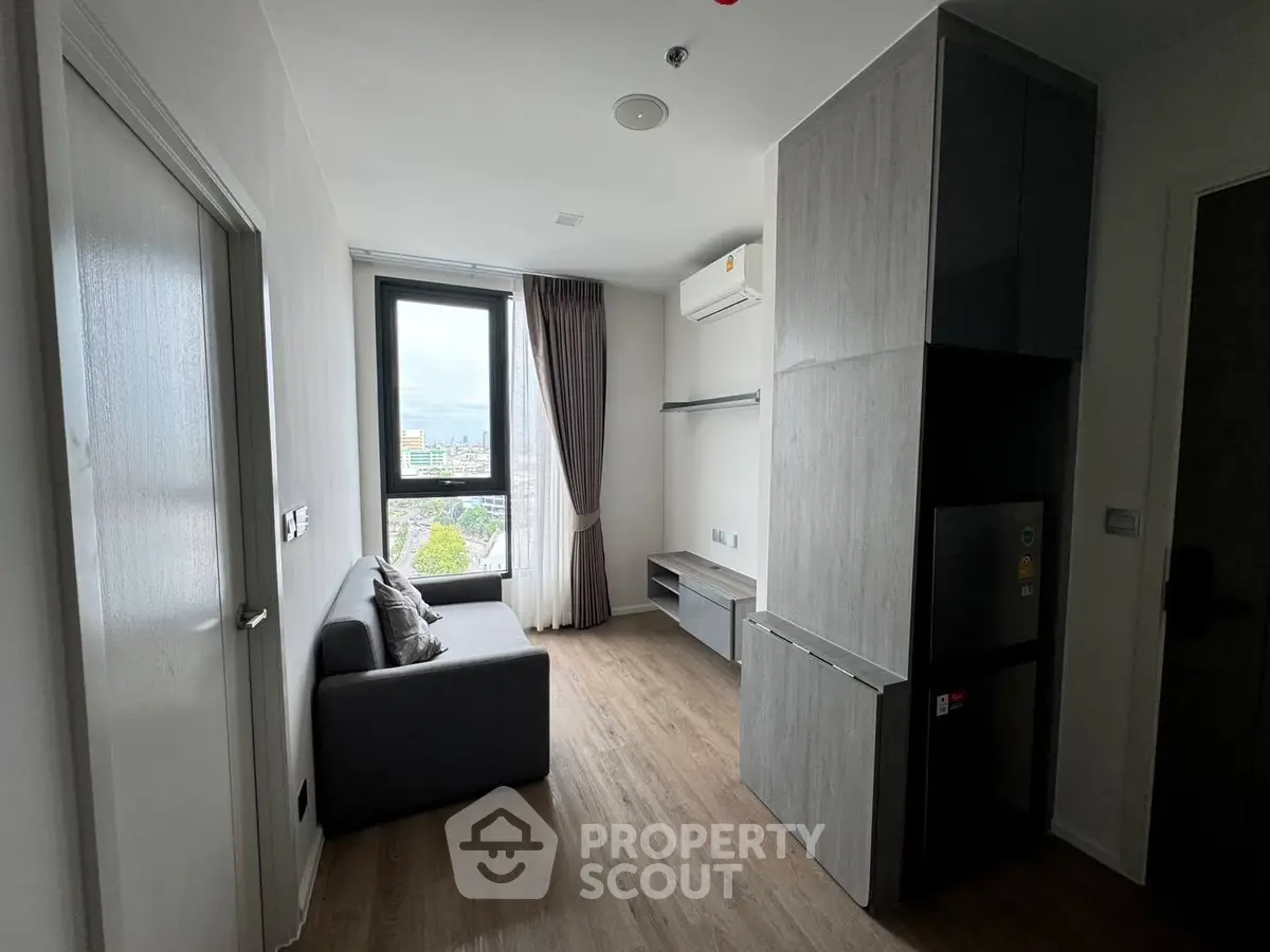 Modern compact living room with city view and sleek furnishings