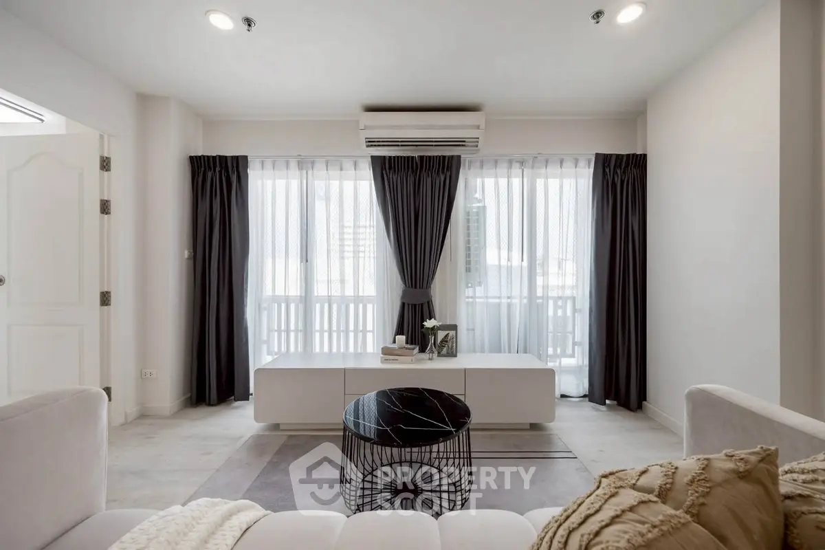 Modern living room with stylish decor and large windows for natural light