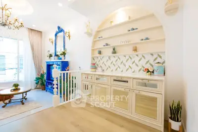 Charming living room with elegant decor and built-in shelving, featuring a cozy seating area and stylish accents.