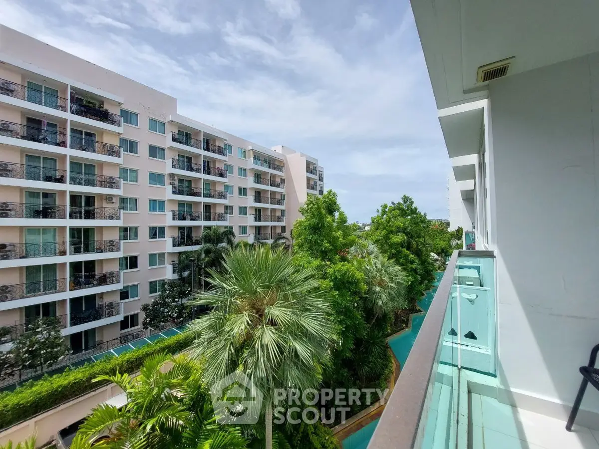Modern apartment complex with lush greenery and spacious balconies offering serene views.
