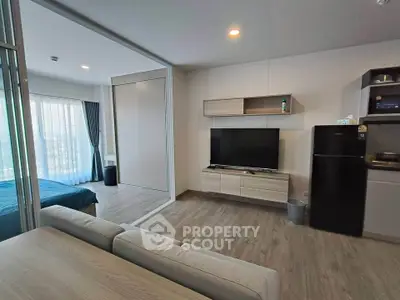 Modern open-plan living room with sleek furniture and natural light