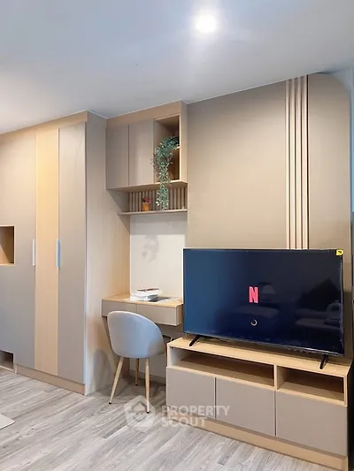Modern living room with built-in storage and sleek TV setup, perfect for cozy entertainment.