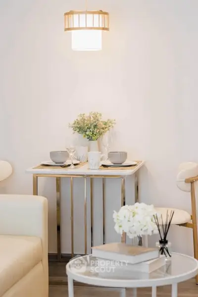 Chic dining nook with elegant table setting and modern lighting in cozy apartment.