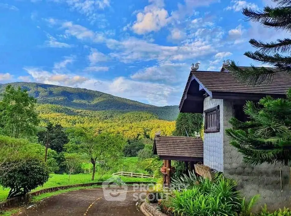 Charming countryside house with scenic mountain view and lush greenery.
