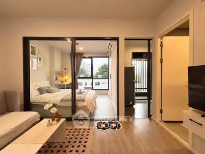 Modern apartment interior with cozy bedroom and stylish living area, featuring large windows and elegant decor.