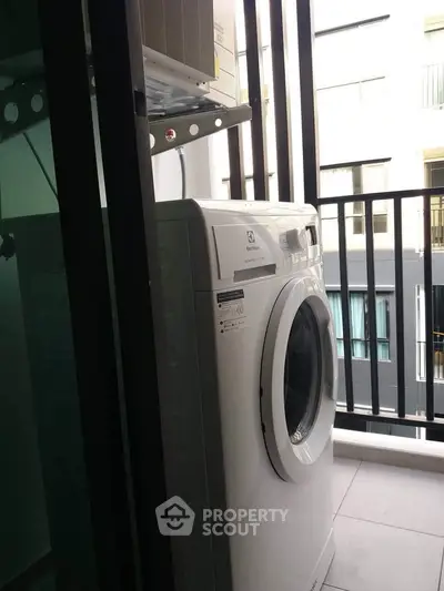 Modern washing machine on a balcony with sleek railing design