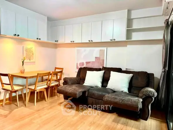 Cozy living room with plush sofa, dining table, and modern decor in a stylish apartment.