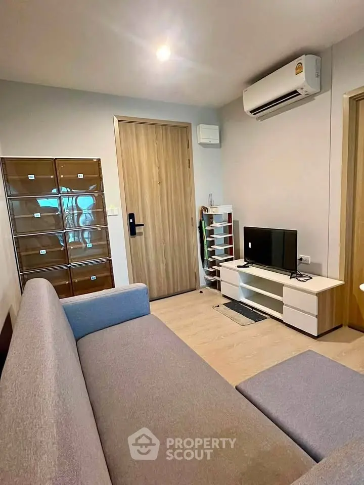 Modern living room with sleek furniture and air conditioning in a cozy apartment.