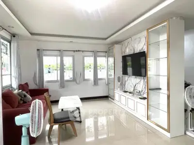 Spacious living room with modern decor and large windows for natural light