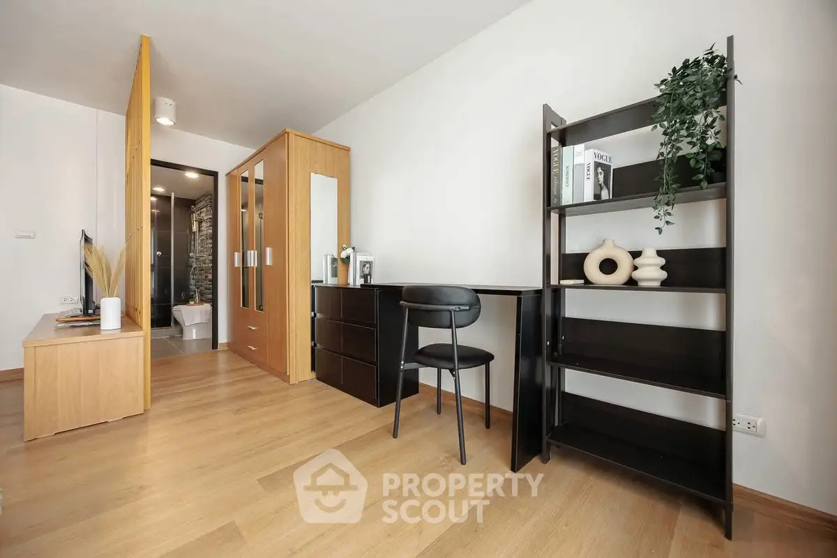 Modern studio apartment with sleek furniture and wooden flooring