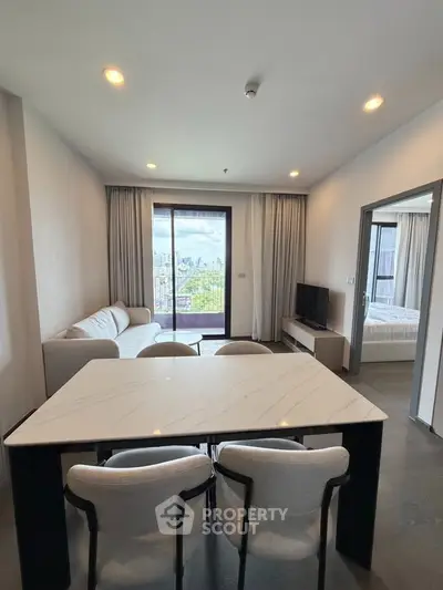 Modern living room with elegant dining area and city view balcony